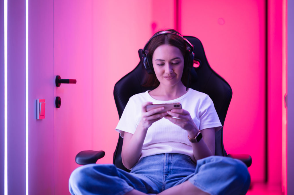 Woman playing mobile game app phone